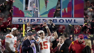 Kansas City Chiefs quarterback Patrick Mahomes (15) holds the Vince Lombardi Trophy after winning the Super Bowl.