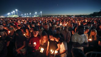 People attend a candlelight vigil after a shooting at Marjory Stoneman Douglas High School, in Parkland, Florida