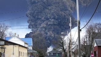 A large plume of smoke rises over East Palestine, Ohio.