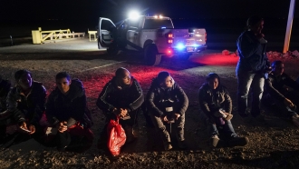 Migrants wait to be processed after crossing the U.S.-Mexico border.