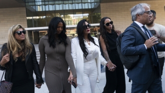 Vanessa Bryant, center, Kobe Bryant's widow, leaves a federal courthouse with her daughter Natalia, and others.