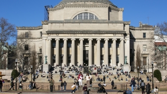 Students relax on the front steps of Low Memorial Library on the Columbia University campus.
