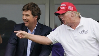Tucker Carlson, left, and former President Donald Trump, at Trump National in Bedminster, N.J., July 31, 2022