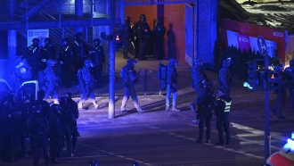 Armed police officers and emergency services near the scene of a shooting in Hamburg, Germany.