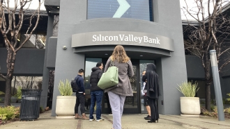 People stand outside the entrance to Silicon Valley Bank in California.