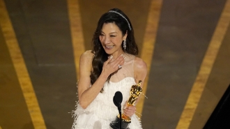 Michelle Yeoh accepts the award for best performance by an actress in a leading role for 