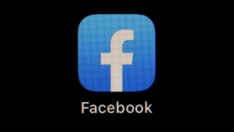Facebook logo on screen.