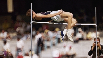 Dick Fosbury, of the United States, clears the bar in the high jump competition at the 1968 Mexico City Olympics