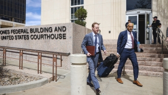 Lawyers exit a federal court building in Texas