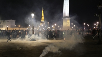 Protesters stand in a cloud of teargas after a demonstration in Paris.