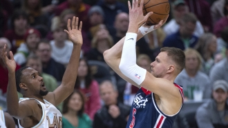 Washington Wizards' Kristaps Porzingis (6) shoots over Cleveland Cavaliers' Evan Mobley.