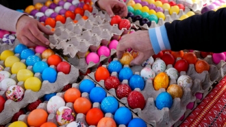 A buyer chooses hand decorated Easter eggs.