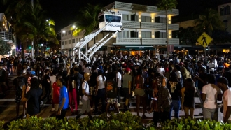 Crowds gather at Ocean Drive and 8th during spring break on Saturday, March 18, 2023.