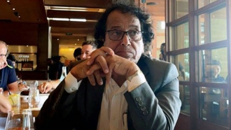 Saad Ibrahim Almadi sits in a restaurant.