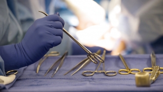 Surgical instruments are used during an organ transplant surgery at a hospital.