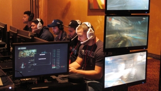 Video game players compete against one another in an esports tournament.