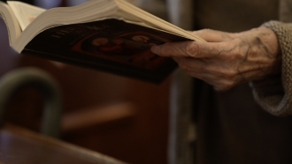A nun holds a book