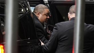 Manhattan District Attorney Alvin Bragg gets out of a car as he arrives at his office.