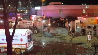 Ambulances and rescue team staffers outside an immigration center in Ciudad Juarez, Mexico.