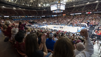 South Carolina and Maryland fans cheer during the first quarter of an Elite 8 college basketball game.