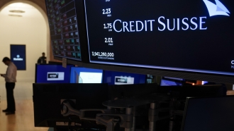 A sign displays the name of Credit Suisse on the floor at the New York Stock Exchange.