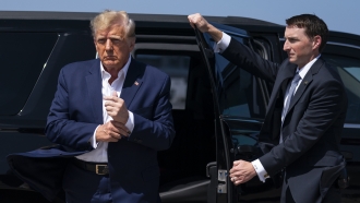 Donald Trump exits a vehicle