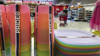 A Pride month merchandise display is at the front of a Target store.