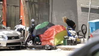 Tents setup on a city sidewalk.