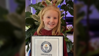 Isla McNabb holds a Guinness World Records certificate.