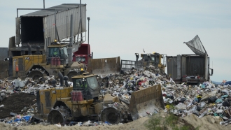 Heavy machinery is used to process trash.