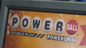 A display panel advertises tickets for a Powerball drawing at a convenience store.