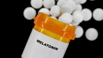 Meltaonin spills out of a pill bottle.