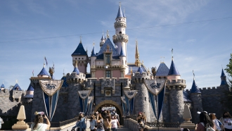 Visitors pass through Disneyland in Anaheim, Calif.