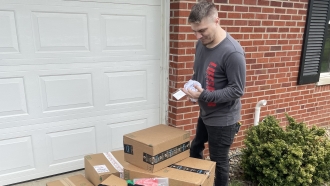 Rob Goodloe looks over boxes from Amazon.
