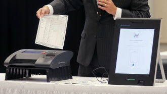 A Smartmatic representative demonstrates his company's system.