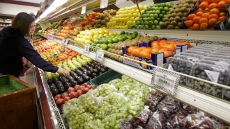 A shopper buys fruits at J.J. & F. Market in Palo Alto, Calif.