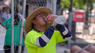 A road worker drinks water in Madrid, Spain