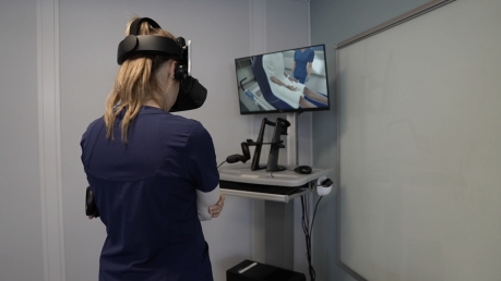 A nursing student learns through virtual reality training.