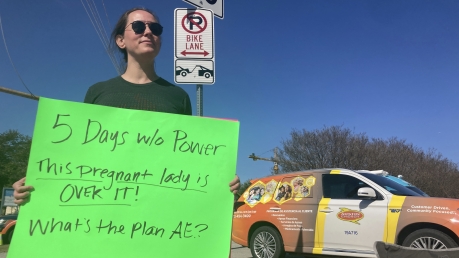 Katy Manganella protesting Austin Energy's handling of an extended power outage.