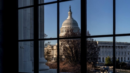 The U.S. Capitol is seen through a window in the Russell Senate Office Building