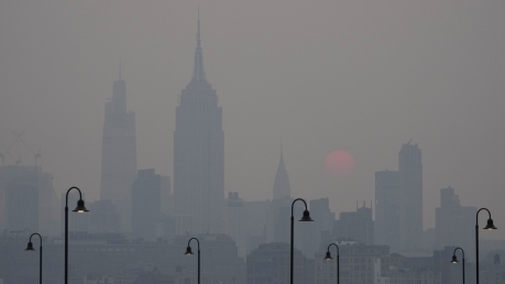 The sun rises Wednesday over a hazy New York City skyline as seen from Jersey City, N.J.