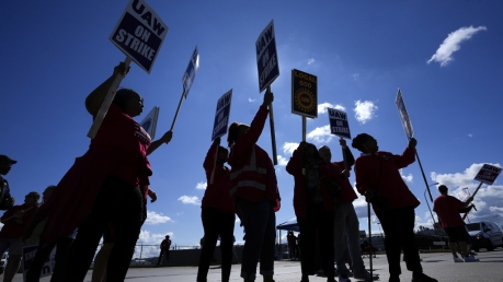 United Auto Workers members walk the picket line at the Ford Michigan Assembly Plant in Wayne, Mich.