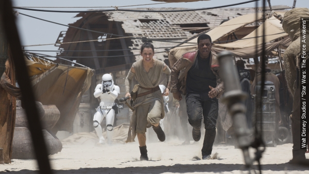 Rey and Fin run from Storm trooper in "Star Wars: The Force Awakens"