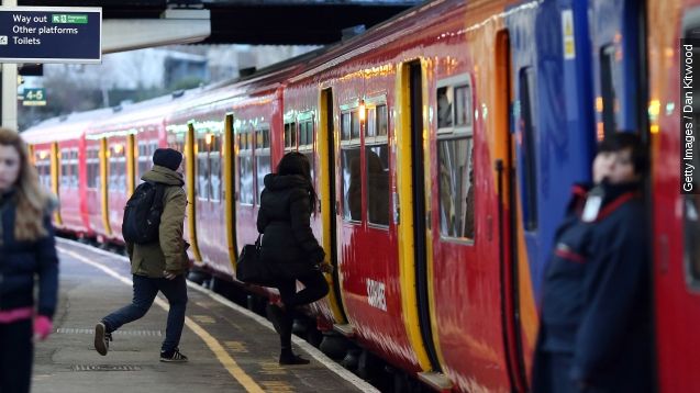 Passengers run to board a train at Clapham Junction on January 2, 2015 in London, England.