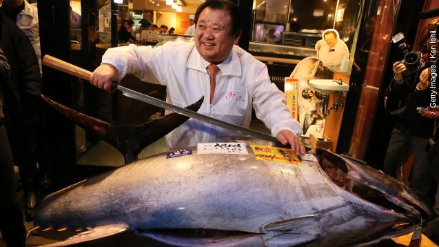 Sushi Restaurant Owner stands with $117,000 bluefin tuna after auction
