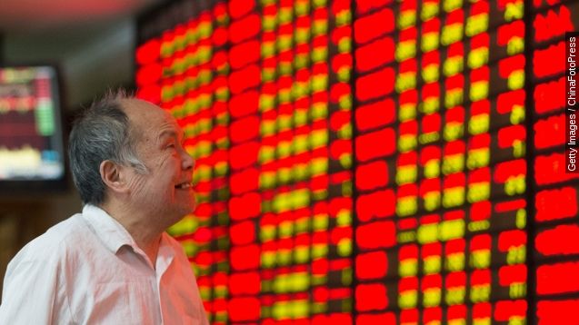 A Chinese trader looks at stock market numbers.