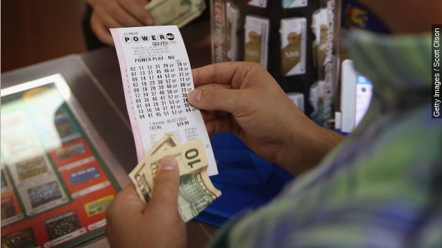 customer at a 7-Eleven store checks the numbers on his Powerball lottery ticket on August 7, 2013 in Chicago, Illinois.