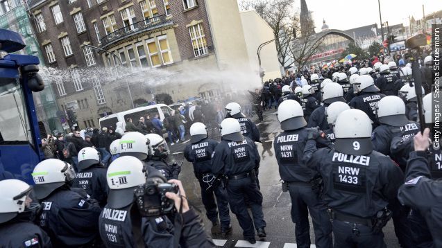 Police use a water cannon to control supporters of Pegida, Hogesa (Hooligans against Salafists) and other right-wing populist groups as they protest against the New Year's Eve sex attacks on January 9, 2016 in Cologne, Germany.