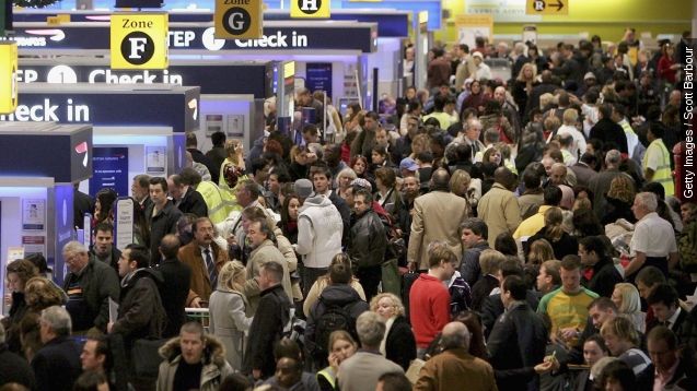 Passengers queue to check in at terminal 1 of Heathrow Airport in London, England.