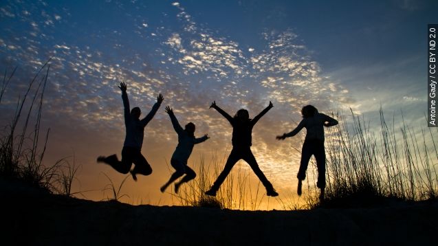 A silhouette of a group of jumping friends